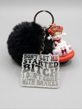 Black Pom Pom Keychain with Playful Racing Girl Skull Panda Charm